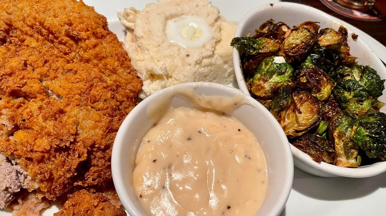LongHorn Steakhouse chicken fried steak, served with gravy on the side, mashed potatoes, and Brussel sprouts