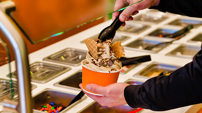 Frozen yogurt in a cup with toppings