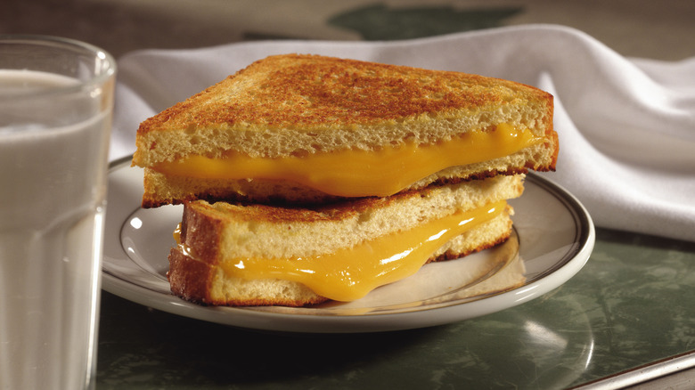 melted cheese oozing out of a grilled cheese sandwich