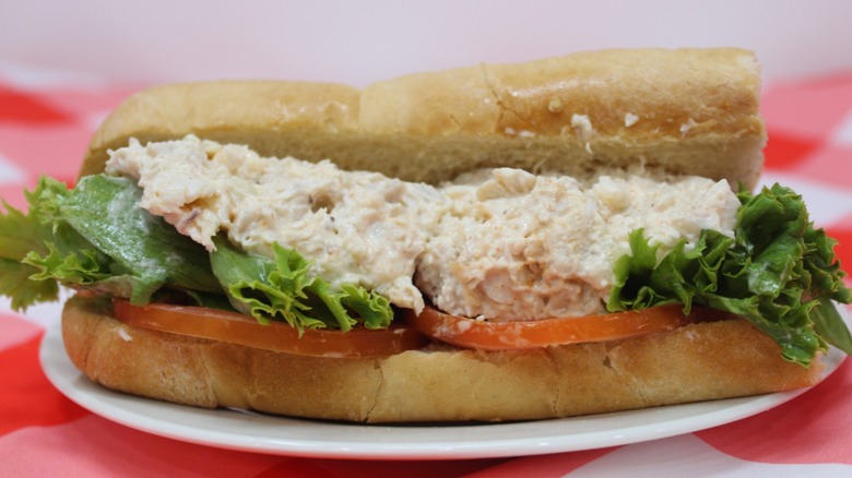 High's chicken salad on a club roll on a red checkered tablecloth
