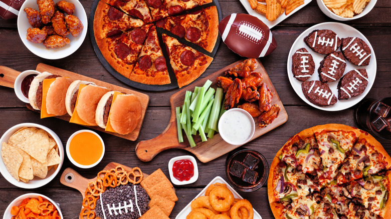 Pizza and Super Bowl snacks on wooden table