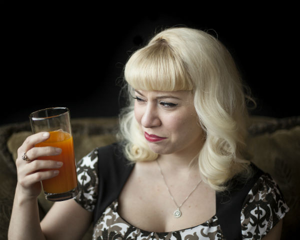Lady making serious gross-out face at a glass