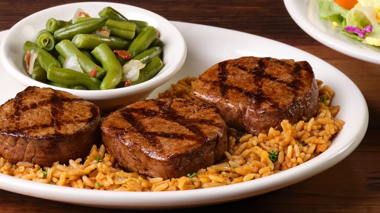 Menu image of Texas Roadhouse filet medallions with rice, green beans, and a salad