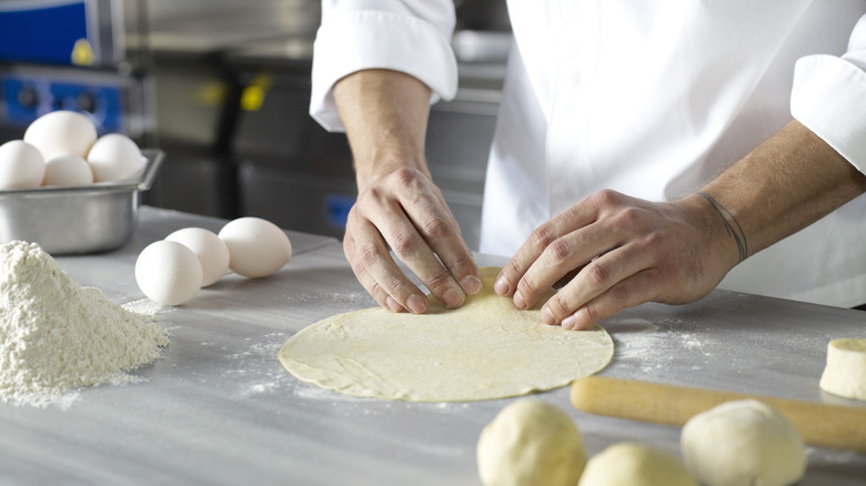 Chef making a dough circle