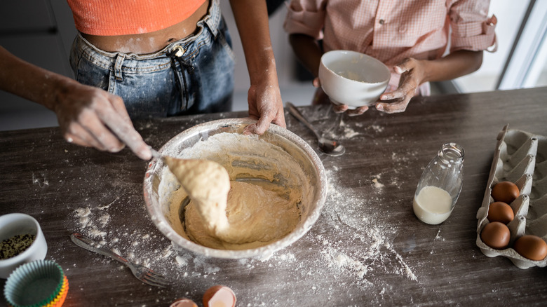 Two people making a cake