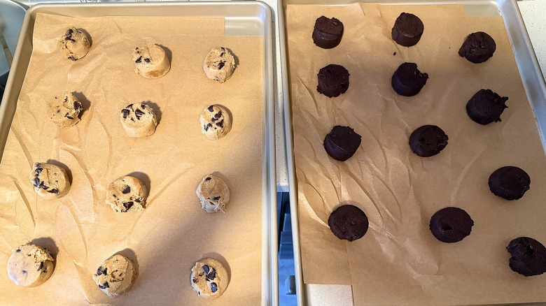 Two cookie trays with unbaked Ghirardelli refrigerated cookie dough on each