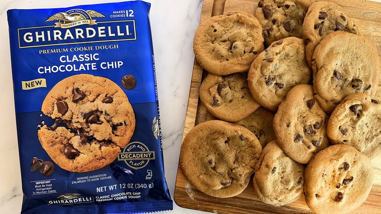 Ghirardelli Classic Chocolate Chip cookie package next to baked cookies on cutting board
