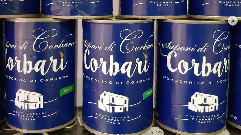 Cans of Pomodoro di Corbara Corbari stacked on a shelf
