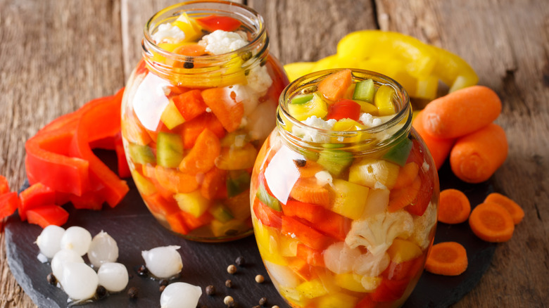 Two jars of giardiniera with veggies