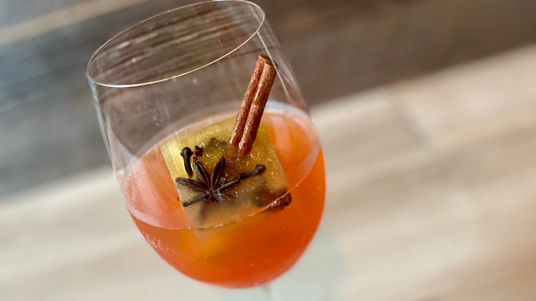 Close up of an apple spritz with glass tilted