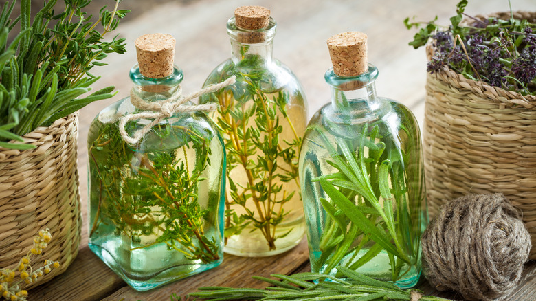 Bottles of oil with herbs inside