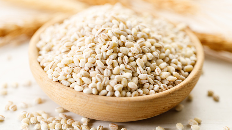 Fresh, uncooked barley in a wooden bowl