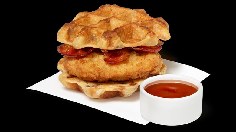 Chick-fil-A chicken and waffle sandwich with a side of maple syrup