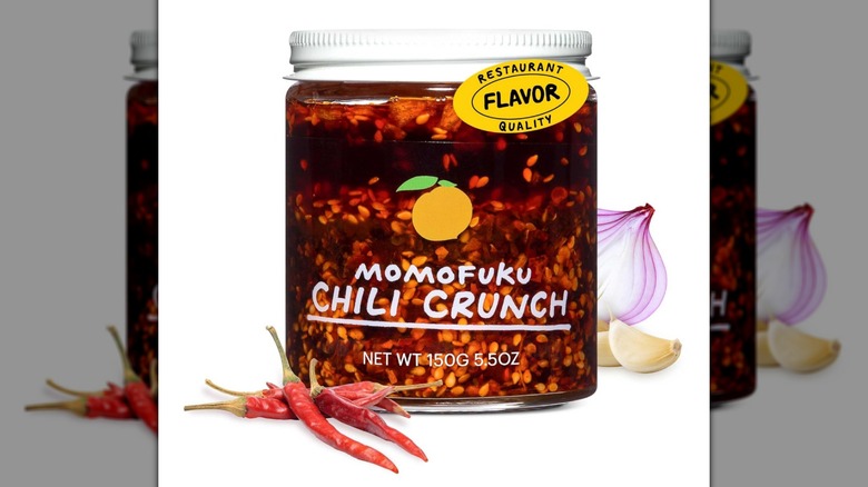 A jar of Momofuku chili crisp oil on a white background
