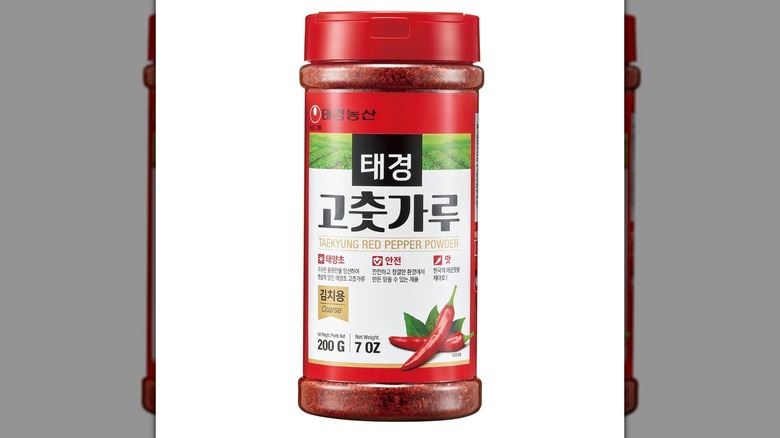 A bottle of Taekyung gochugaru seasoning on a white background