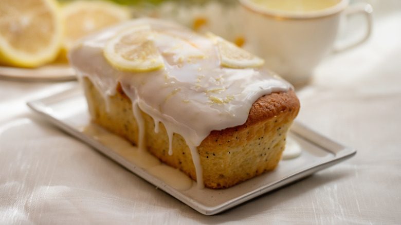 Lemon cake drizzled with syrup on a tray