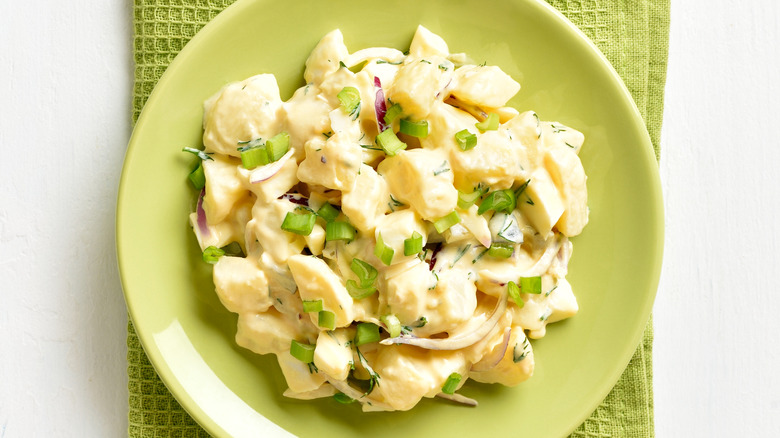 Bowl of potato salad on a green cloth napkin