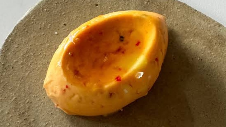 A small portion of maple chile butter with the maple pooled in the center