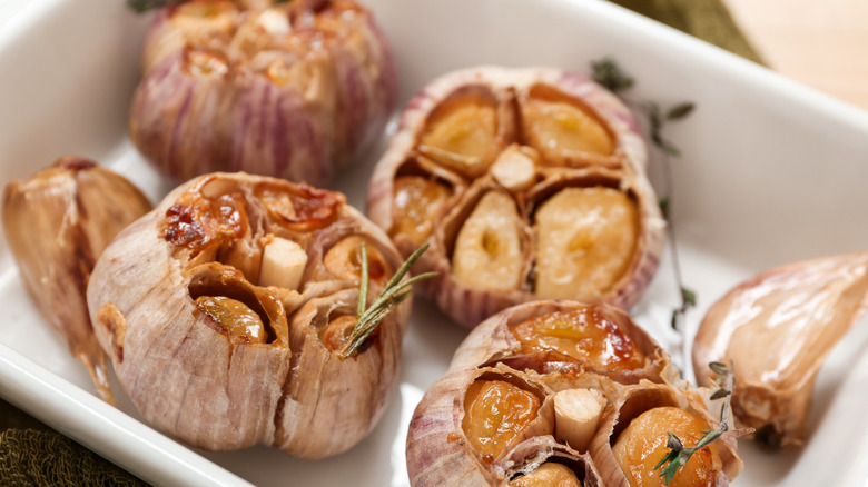 Roasted garlic cut open in a dish