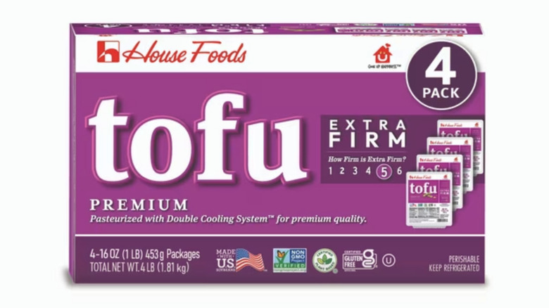 Extra firm tofu in a purple package on white background