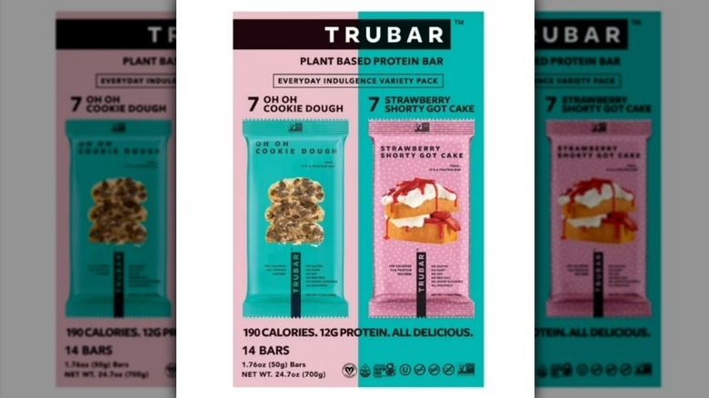TRUBAR protein bars in teal and pale pink packaging on white background
