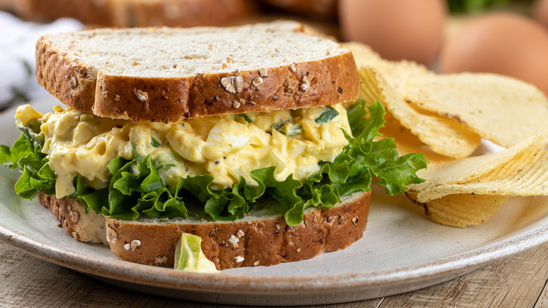 Egg salad on multigrain bread with chips