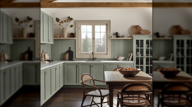nature-toned green farmhouse kitchen with a wooden table.
