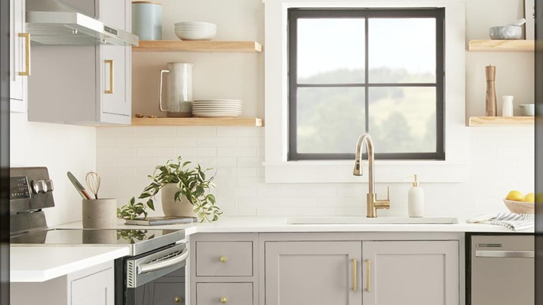 gray taupe modern kitchen design with open shelving and brass knobs.