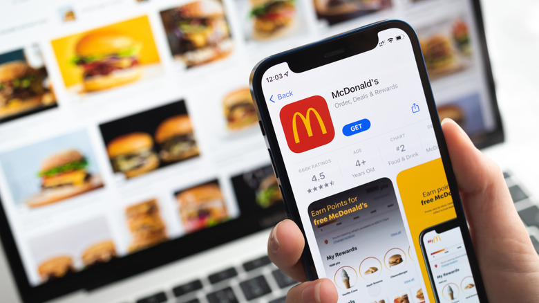 Hand holding phone featuring McDonald's app
