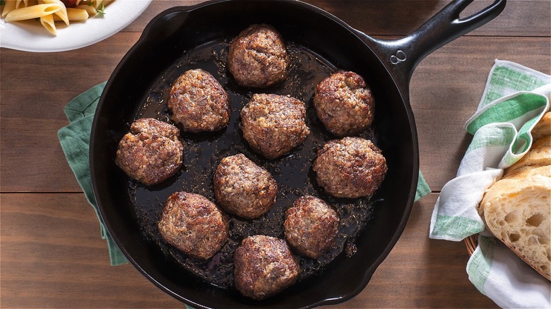 Cooked meatballs in cast iron skillet