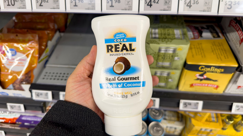 Container of Simply Squeeze Coco Real in a hand