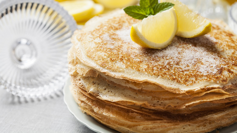 English style pancakes topped with lemon wedge