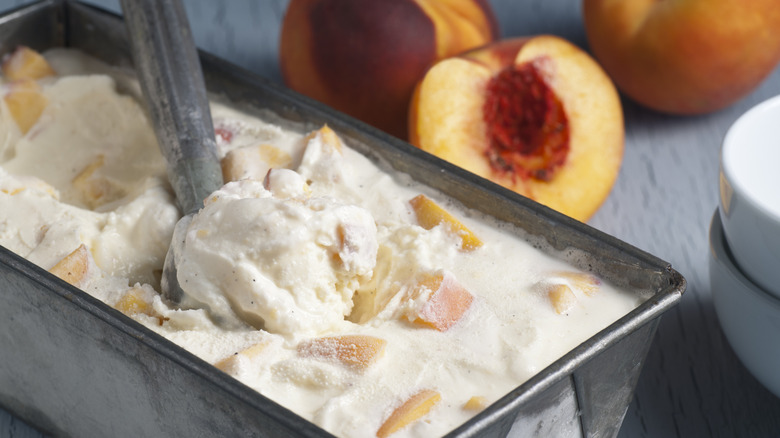 Homemade fresh peach ice cream in a metal container