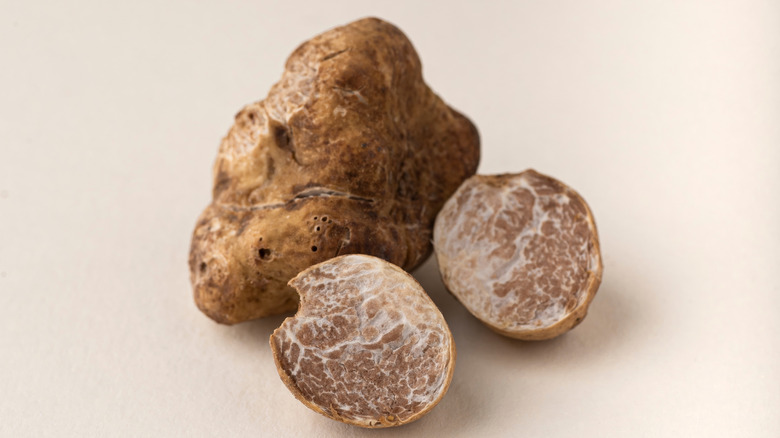 Whole and halved white truffles