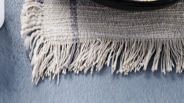 A close-up picture of chicken kiev cut open, next to potatoes and lemon.