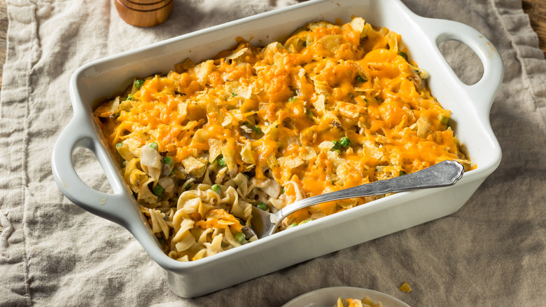 Tuna noodle casserole, a large metal spoon inside.