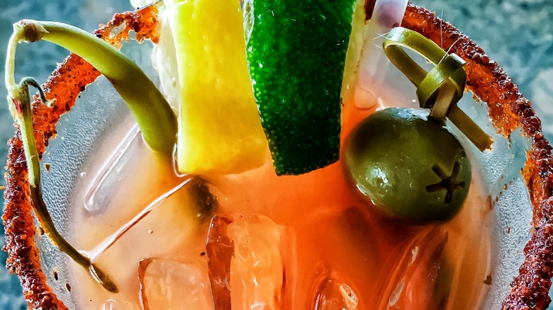 Closeup of a Bloody Mary with vegetable and fruit garnishes