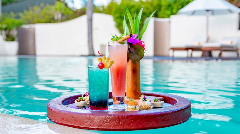 tropical cocktails floating in pool