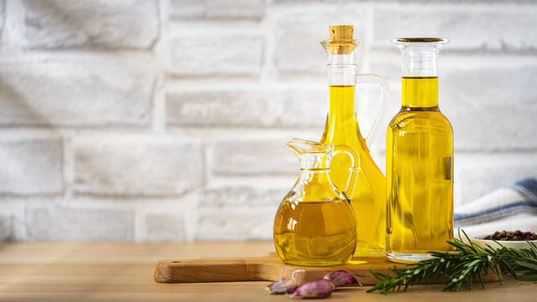 Three bottles of oil on a table