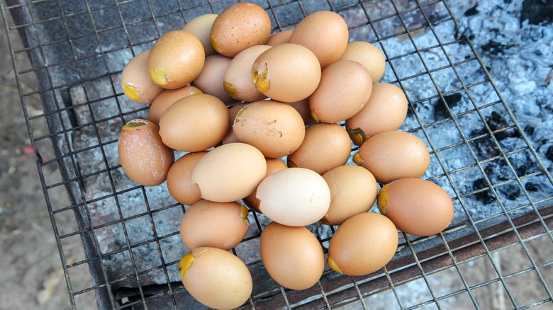 brown eggs cooking over open fire grill 