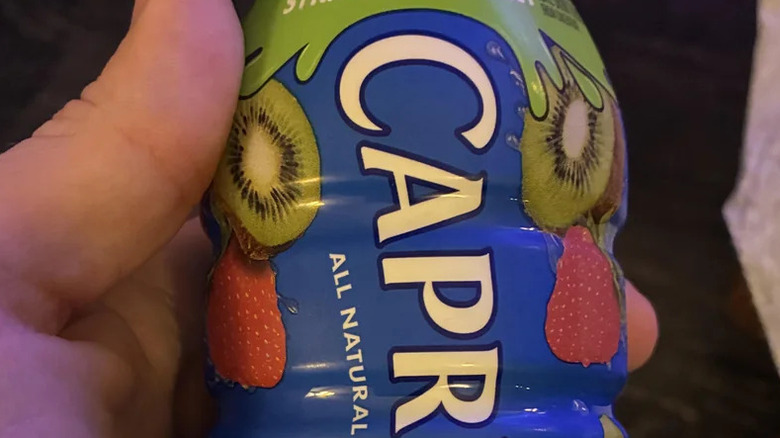 Hand holding a Capri-Sun bottle