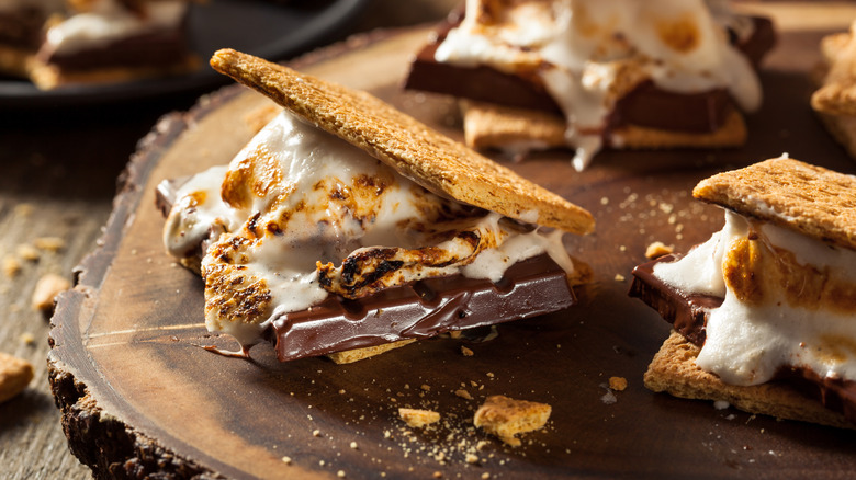 Close up of assembled s'mores on wood slab