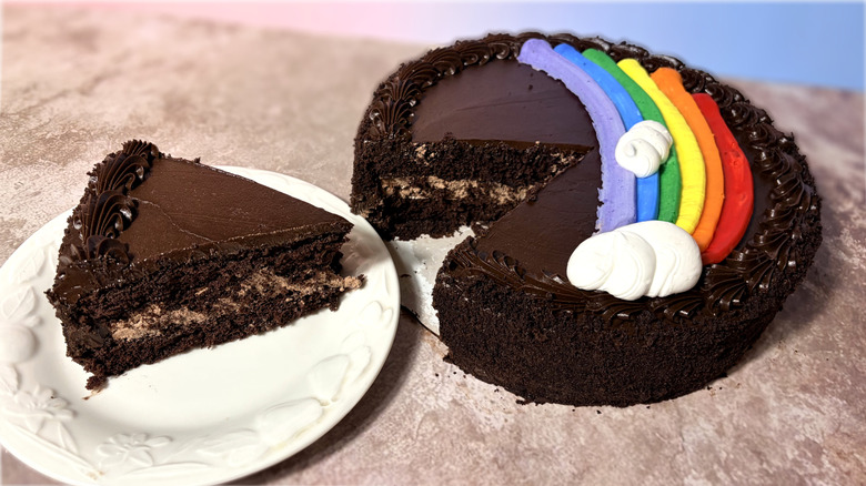 Chocolate cake, with one slice on a plate