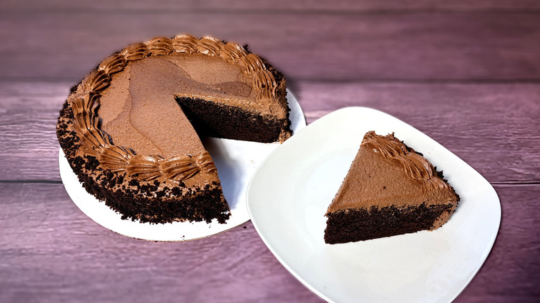 Chocolate cake, with one slice on a plate