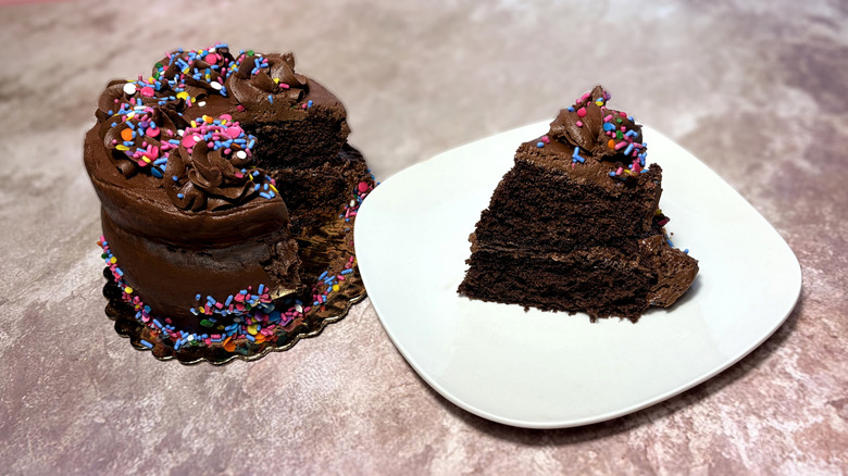 Chocolate cake, with one slice on a plate