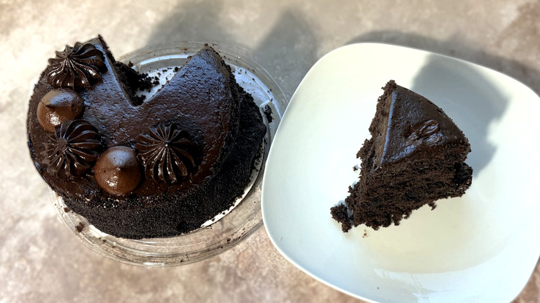 Chocolate cake, with one slice on a plate