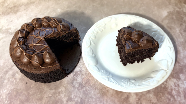 Chocolate cake, with one slice on a plate