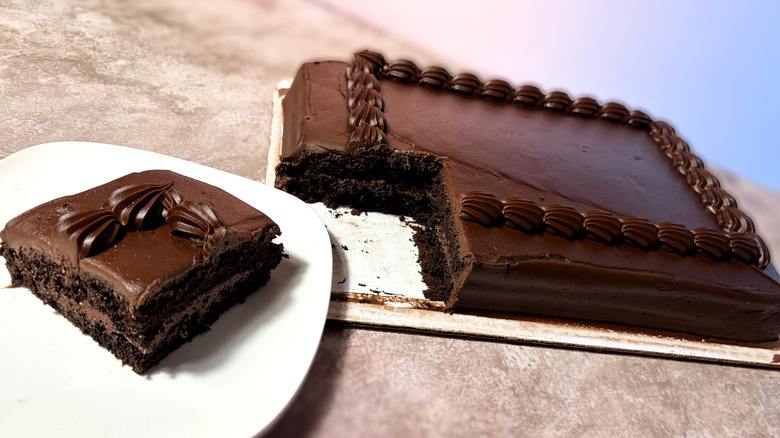 Chocolate cake, with one slice on a plate