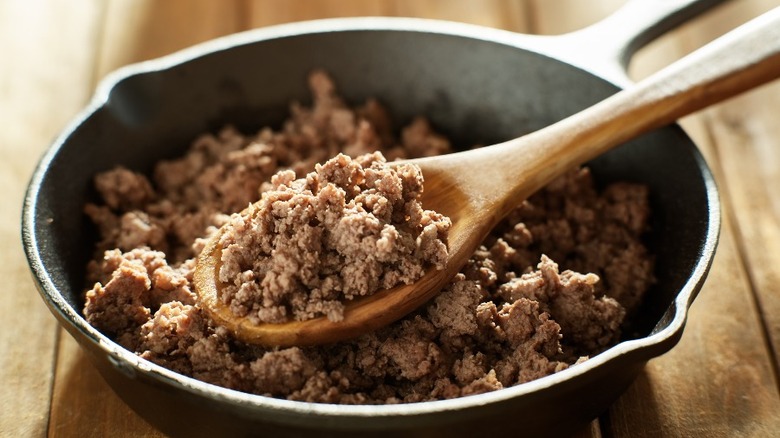 Ground beef in pan with spoon