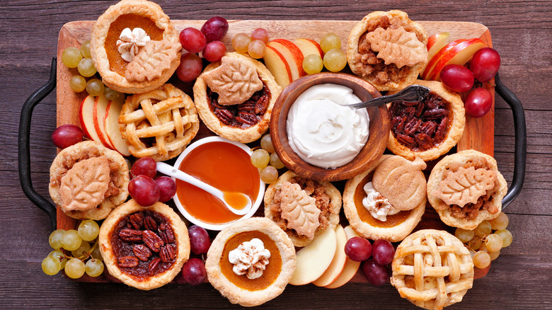 variety of mini pies on a wooden board